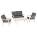 A group of grey POLYWOOD Vineyard outdoor chairs and a table with black cushions.