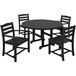 A black POLYWOOD La Casa dining set with four chairs around a round table on an outdoor patio.