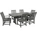 A POLYWOOD slate grey dining table with six chairs on an outdoor patio.
