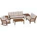 A POLYWOOD wooden patio set with beige cushions on a white background including a couch, rocking chair, and table.