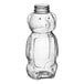 A clear plastic bottle shaped like a bear with a lid.