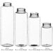 A group of clear 16 oz. cylinder PET sauce bottles with black lids.