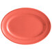 A close up of a Tuxton Cinnebar oval china platter with a bright coral color.