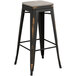 A black and brown Lancaster Table & Seating barstool with a metal base.