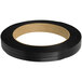 A black coil of PAC Strapping Products black polypropylene strapping with a white oval label.