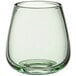 A clear stemless wine glass with a green rim.