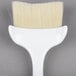 A white Winco pastry/basting brush with a long white handle.