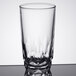 An Arcoroc clear glass tumbler with a patterned design on a table.