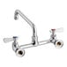 A chrome Regency wall mount faucet with silver and red and blue handles.