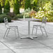 A Lancaster Table & Seating square outdoor table with chairs on a patio.