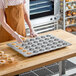 A large aluminized steel muffin or cupcake pan with 35 cups, designed for baking multiple cupcakes or muffins at once.