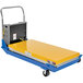 A blue and yellow Vestil battery-powered scissor lift cart with a yellow rectangular tray on it.