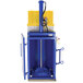 A blue and yellow Vestil hydraulic drum crusher and compactor.
