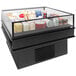 A black Structural Concepts refrigerated mobile island display case with food inside.