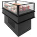 A black Structural Concepts refrigerated display case with food inside.