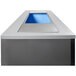 A rectangular grey box with a blue light inside.