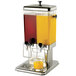 A Tablecraft dual bowl beverage dispenser filled with orange juice and another beverage.