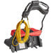 A red and black Sanitaire wide area vacuum cleaner with a yellow cable.