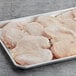 A tray of frozen Brakebush Farm Pantry boneless skinless chicken breast butterfly fillets.