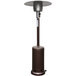 A bronze outdoor heater with a round base and white top.