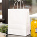 Trim 8" x 4 1/2" x 10 1/4" White Paper Shopping Bag with Handles - 250/Bundle Main Thumbnail 1