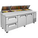 A Turbo Air stainless steel pizza prep table with 2 doors and 2 drawers on a counter.