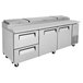 A large stainless steel pizza prep table with drawers.