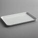 A white rectangular Cambro market tray on a gray surface.