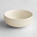 An Acopa Pangea fog white porcelain nappie bowl on a white surface.