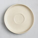 A white Acopa Pangea porcelain saucer with a circle in the center.