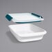 A white rectangular plastic OXO food storage container with a blue lid.