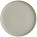 A close up of an Acopa Pangea white porcelain plate with a small rim.