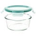 An OXO Good Grips clear round glass container with a green lid.