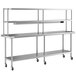 A stainless steel Regency expeditor table with a double overshelf and an undershelf on wheels.