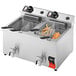 A Vollrath Cayenne dual countertop deep fryer with two frying baskets filled with french fries.