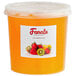 A plastic container of Fanale Passion Fruit Popping Boba with orange liquid inside.
