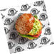 A burger wrapped in a white Choice customizable liner with a logo.