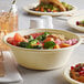 A table with Tellus Products bagasse bowls filled with a meal that includes broccoli and grapefruit.
