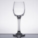 A close-up of a clear Chef & Sommelier cordial wine glass on a table.