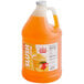 A jug of orange Carnival King Mango Slush Syrup.