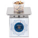An Edlund Four Star Series portion scale with a plastic container of nuts and seeds on top.