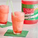 A glass of Jolly Rancher Sugar Free Watermelon Slushy with a straw.
