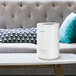 A white Guardian Technologies Germ Guardian air purifier tower on a table.