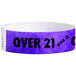 A purple Carnival King Tyvek wristband with black text that reads "OVER 21"