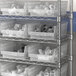Regency Clear plastic containers on a shelf.