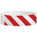 A red and white striped Carnival King paper wristband.