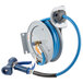 A T&S open epoxy coated steel hose reel with a hose attached.