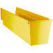A yellow plastic Regency shelf bin with open compartments.