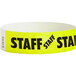 A yellow Carnival King wristband with black "STAFF" text.