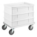 A white dough proofing set with three stackable bins and an aluminum dolly with four caster wheels.